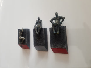 Small Beings Sitting on Logs. Set of 3 by Yelitza Diaz |  Side View of Artwork 